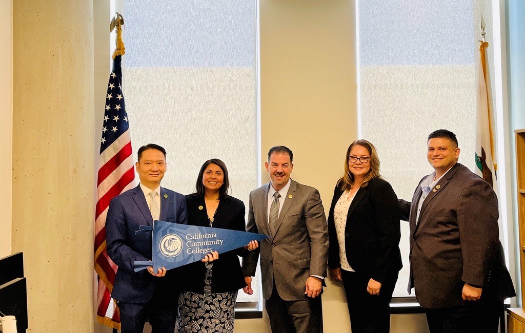 From left: Assemblymember Tri Ta holds a California Community Colleges banner as he poses with Interim Chancellor Daisy Gonzales, Board of Governors Member Bill Rawlings, Vice Chancellor of Workforce and Economic Development Sandra Sanchez and Board of Governors Member Paul Medina.