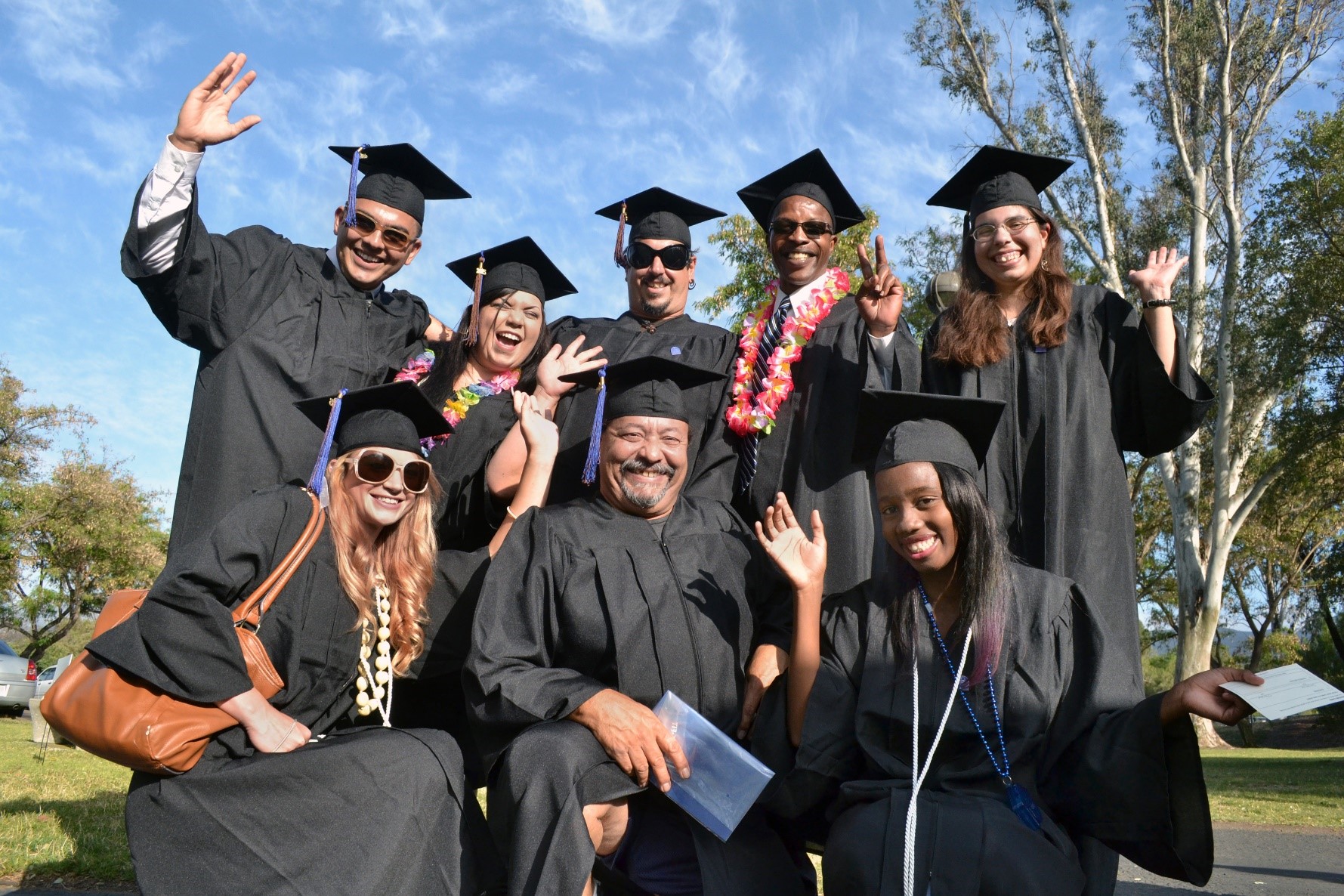 photo of eight graduating students in black robes