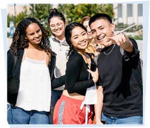 four smiling students one pointing at viewer