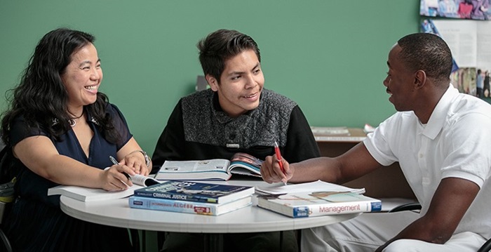 Three students sitting around a table