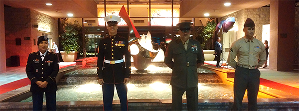 four people in military uniforms standing in a row