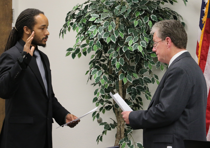 Trustee swearing in with a male getting sworn in by another man