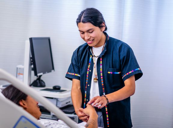 A Native American California community college nursing student practices on a patient